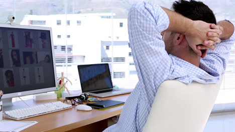 Photo-editor-relaxing-on-his-swivel-chair