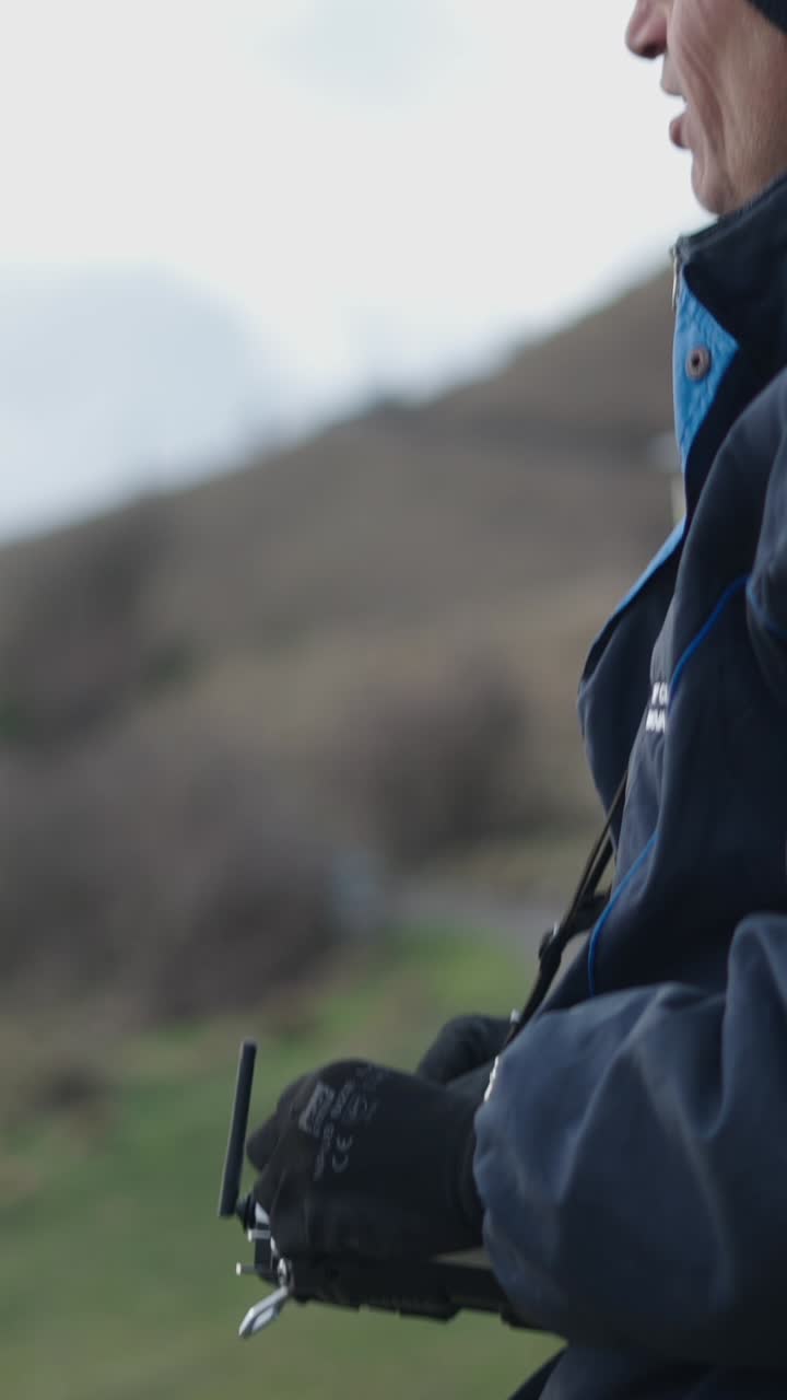 Person holding a controller outdoors