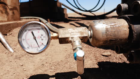 part of the metal pipe with faucet and manometer. close up. equipment for drilling oil and gas.