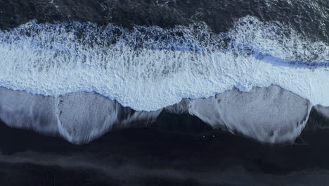 black sand beach reynisfjara on the south coast of iceland - aerial drone shot