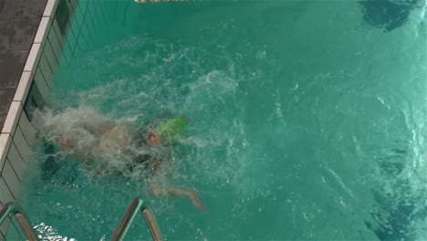 fit woman turning in the pool