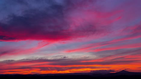 Time-lapse-of-colorful-sunset-clouds-over-Ostrzyca-Proboszczowicka-mountain