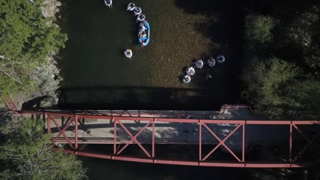 aerial view people in rafts floating under bridge on boise river