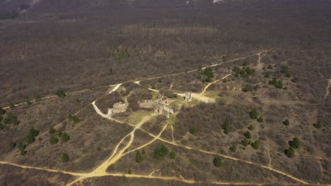 High-altitude-drone-footage-from-ruins-of-an-castle-in-Pilisborojeno,-Hungary