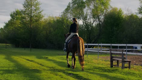 woman horseback riding in a countryside setting