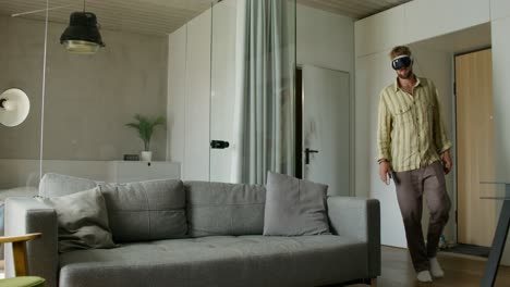 man using vr headset on a couch at home