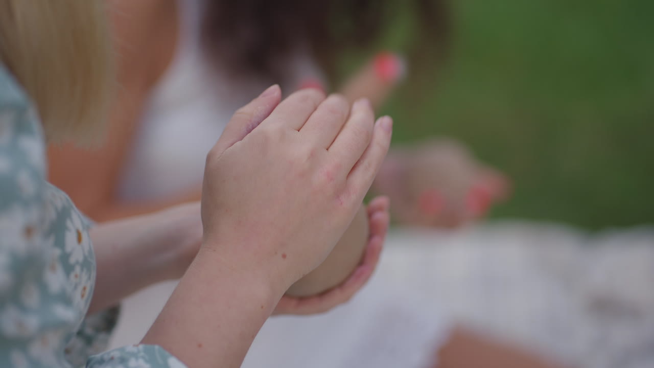 Women's hands close-up sculpt an object from clay in a group of people in nature in an open area. Training in clay modeling hobbies creativity handmade work. Close-up modeling of the product.