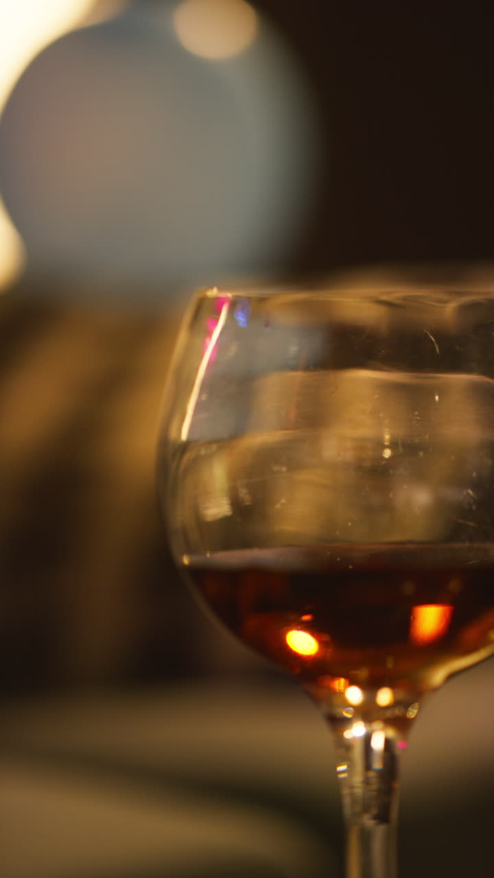 Vertical Video Close Up Of Red Wine In Glass On Table After House Party