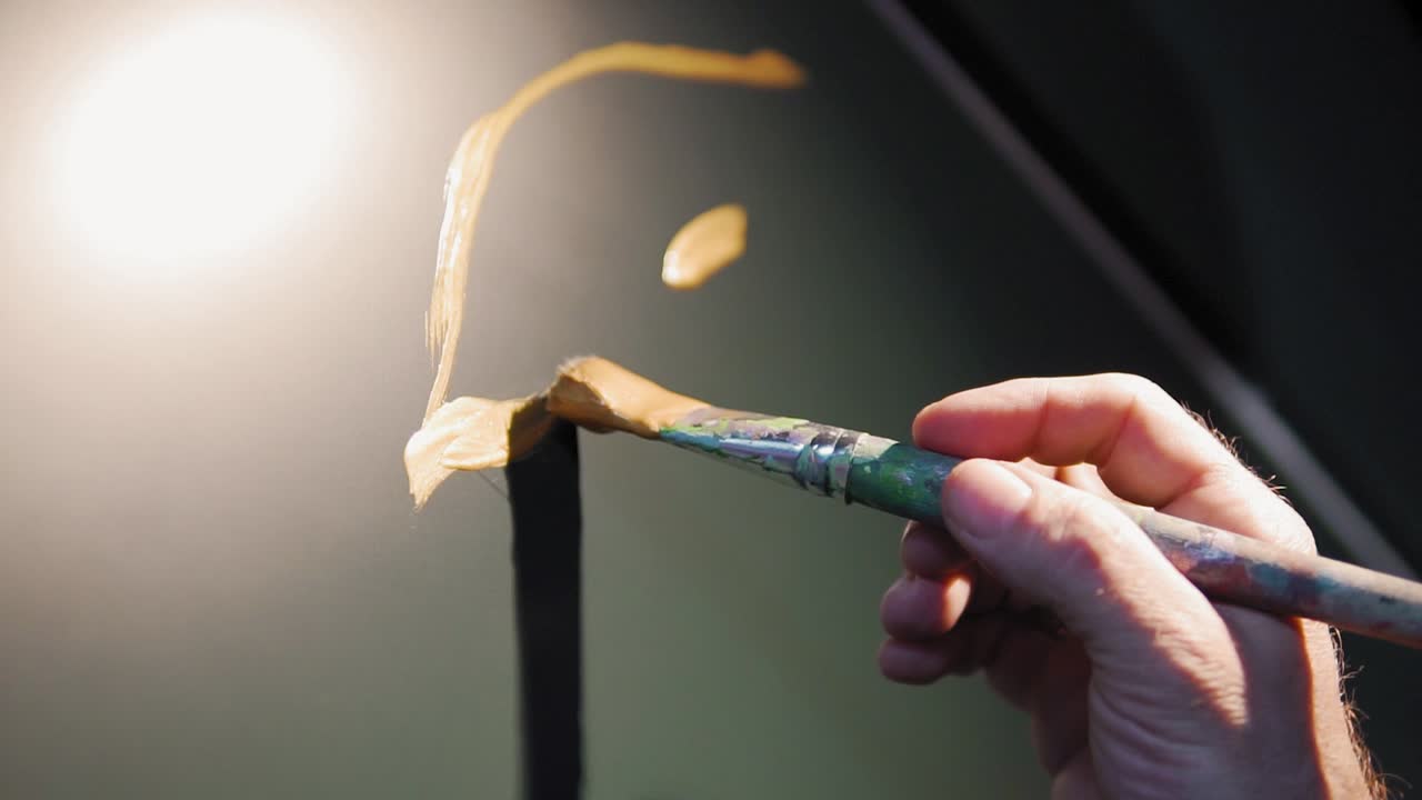 슬로우 모션:붓으로 그림을 그리고 즐겁게 노는 사람의 낮은 각도