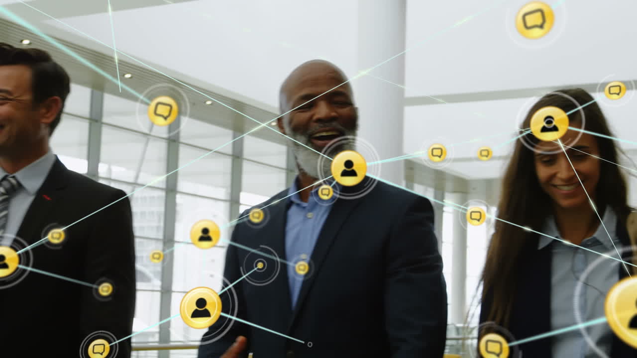 Animation of network of connections with icons over diverse business people working at office