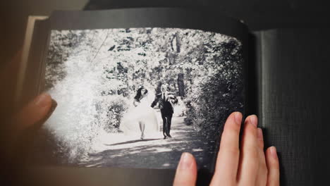 Lady-strokes-faded-image-of-grandparents-wedding-in-album