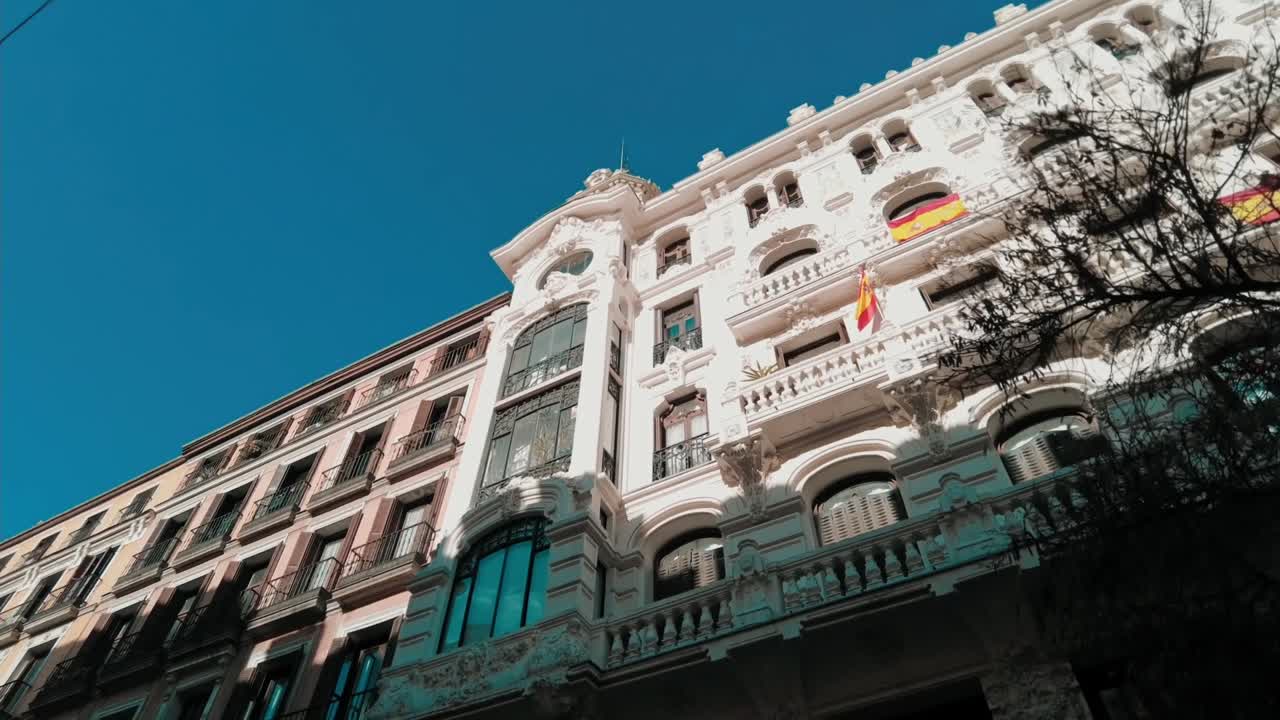Looking up to high building on street in the city center of madrid
