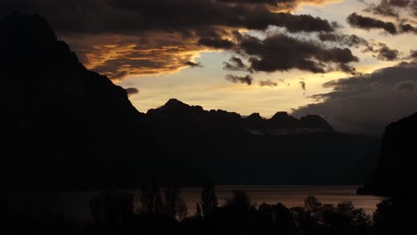 stunning sunrise captured by a drone over lake walensee in the swiss alps, with breathtaking views of the surrounding mountains and serene clouds.