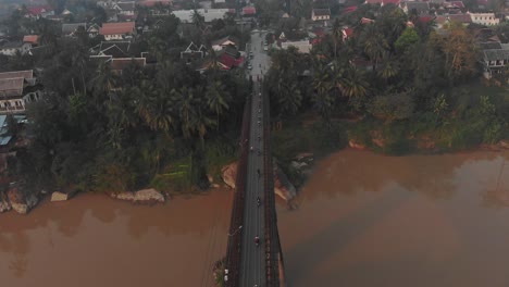 flying over bridge at luang prabang laos during early morning, aerial