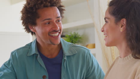 Excited-Couple-At-Home-Hugging-And-Celebrating-Together