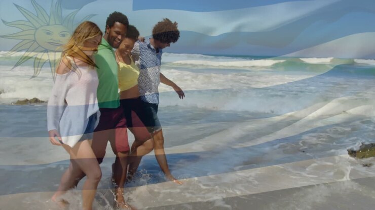 Animation of flag of uruguay over diverse friends at beach
