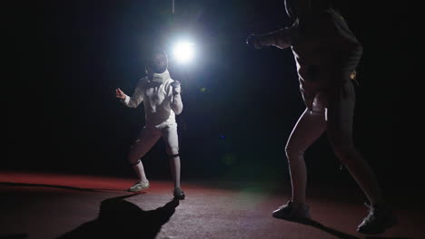 two fencers compete in a match