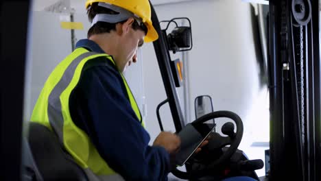 male worker using digital tablet in forklift 4k