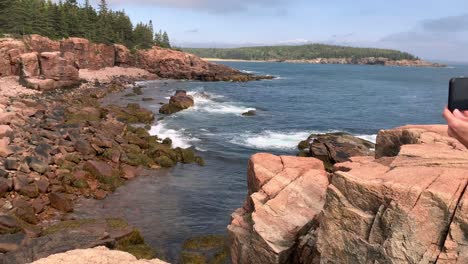 4k lady takes selfie photo along maine's beautiful coastline