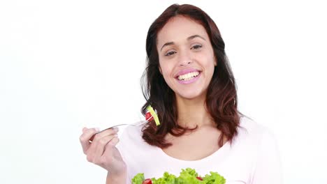 Pretty-smiling-woman-eating-salad