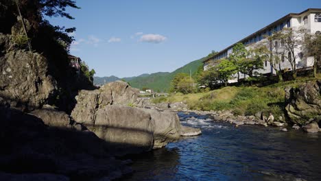 yoshida river flowing through gujo-hachiman on warm japanese summer day