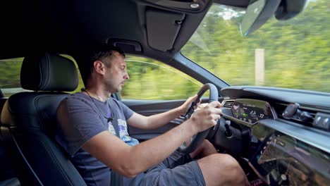 luxury car interior. man drives car along the highway