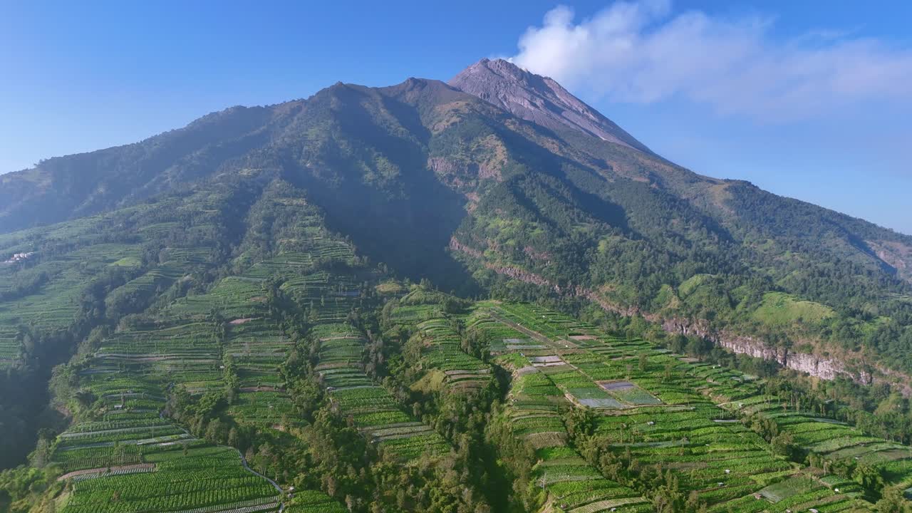 Panoramic view Merapi Volcano on Indonesia. Active volcano emittin smoke. 4K aerial drone video.
