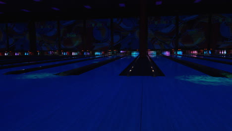 wide shot of bowling lanes during night or disco bowling