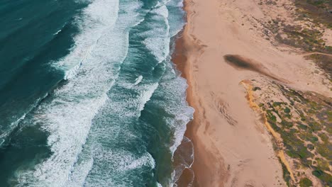 California-Big-Sur-sandy-beach-slow-motion-along-Highway-One,-famous-road-trip-route-aerial