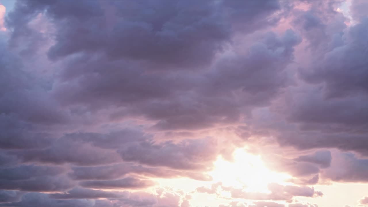 Dreamy sunset sky with pink and purple clouds, captured from a low angle