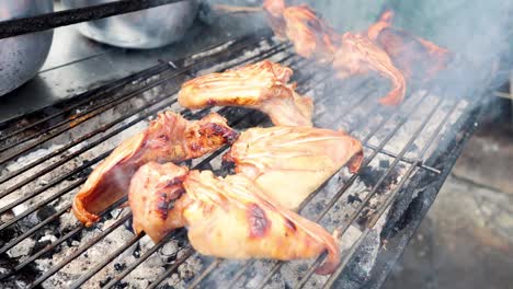 pig ears cooking on a smoky grill