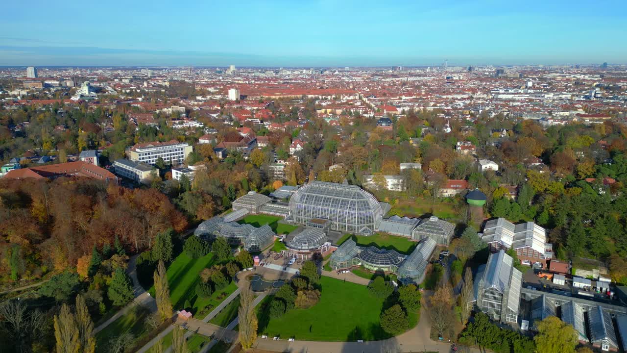 Botanical Garden Berlin 100-year old Victoria House greenhouses surrounded by autumn trees and urban landscape. Great aerial view flight panorama overview drone