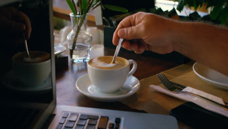 someone stirring coffee with spoon 4k