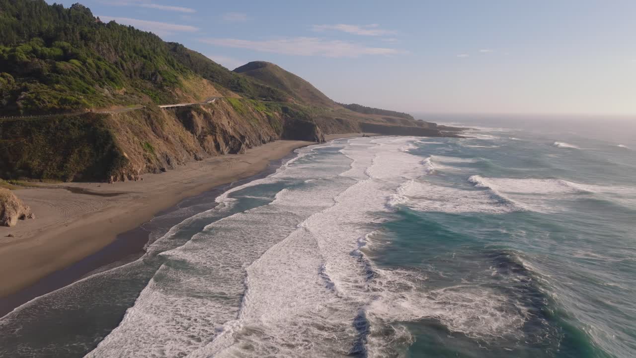 Serene California coast with waves, captured under clear, sunny skies