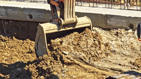 Close-up-of-excavator-moving-earth-for-public-housing