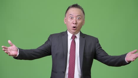 성숙한 일본 사업가가 충격과 놀라움을 느다.