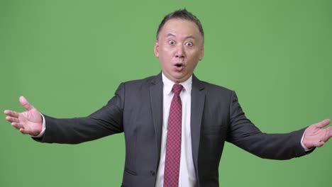 mature japanese businessman shocked and surprised