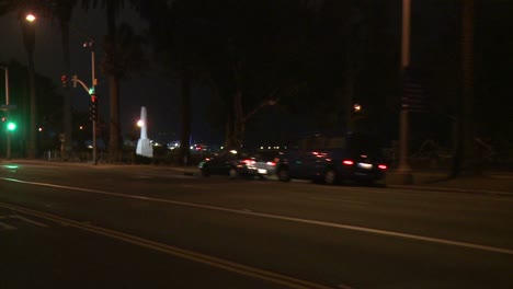 A-Car-Travels-Along-A-Street-At-Night-In-Santa-Monica-California-As-Seen-Through-The-Rear-Window-At-An-Angle-6