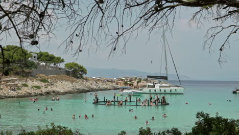 Pan-wide-view-of-beautiful-beach-of-Aponisos,-located-at-Agistri-island,-Greece,-during-summer-of-2020,-slow-motion-120fps