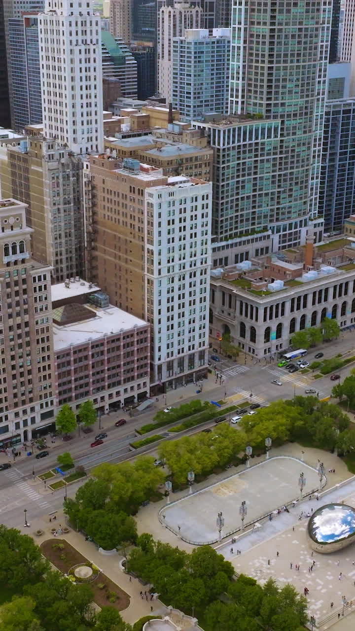 Fantastic Millennium Park with Cloud Gate sculpture. Wonderful Chicago architecture surrounding green area. Vertical video