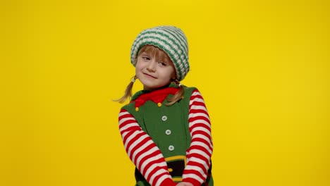 Shy-shamed-child-girl-in-Christmas-elf-Santa-helper-costume-posing-looking-camera,-feels-guilty