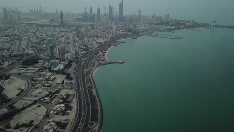 aerial view of the arabian gulf road in kuwait. revealing shot of kuwait city skyline with an upward tilt