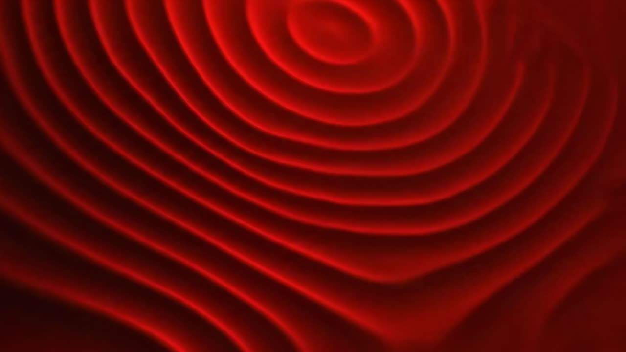 Abstraktit punaiset aallot luovat hypnoottisen kuvion. Ylhäältä alaspäin kuvattu kulma korostaa videon sulavaa liikettä. Live.