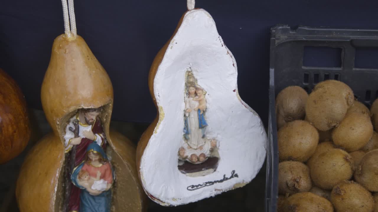 Gourds with saints and our lady for sale at a arts and crafts market stand at a winter market in the north of Portugal