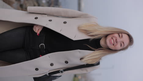 woman wearing a beige coat and black pants