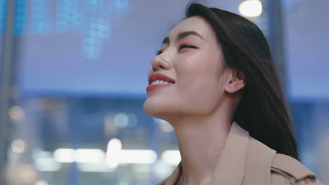 smiling woman in a city at night