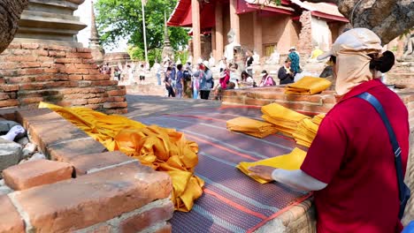 monk organizing robes at ayutthaya temple