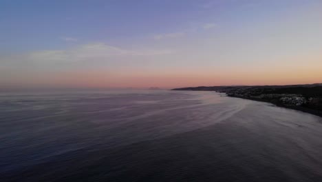 mediterranean sea sunset at costa del sol beach, estepona, spain - aerial drone shot