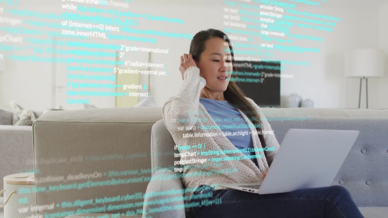 Developer responding to floating code lines by reviewing code on laptop in home to complete build