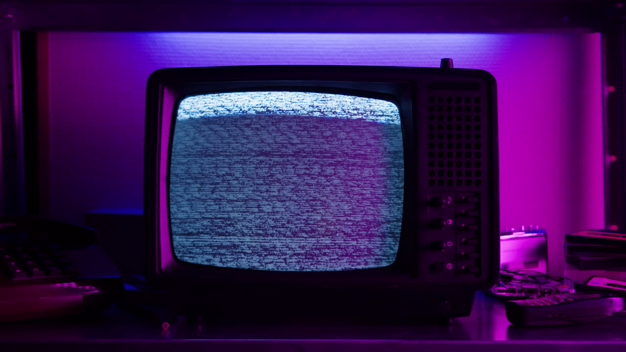 Retro TV, vintage television In a nostalgic setup, a retro TV displays grain on screen, scary halloween night device good for chroma key and green screen.